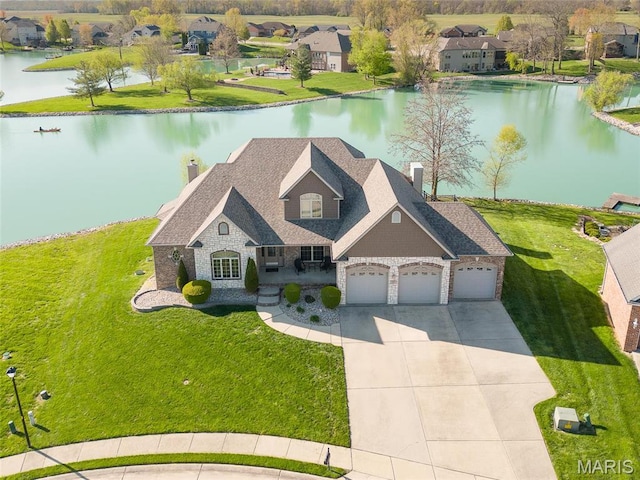 2017 Richview Dr, Saint Jacob, IL 62281 - view of front of house featuring a chimney, stone siding, an attached garage, concrete driveway, and a water view
