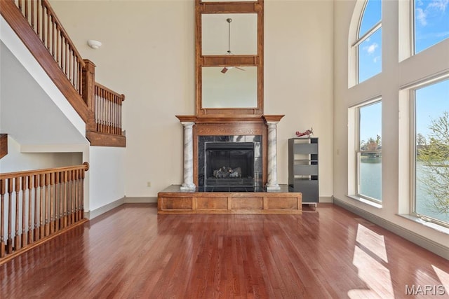 2017 Richview Dr, Saint Jacob, IL 62281 - unfurnished living room with a towering ceiling, a premium fireplace, healthy amount of natural light, and wood finished floors