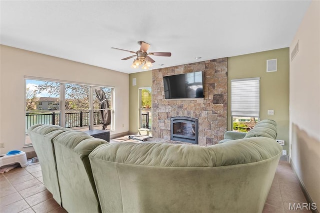 2017 Richview Dr, Saint Jacob, IL 62281 - living area featuring baseboards, tile patterned floors, a ceiling fan, and a stone fireplace