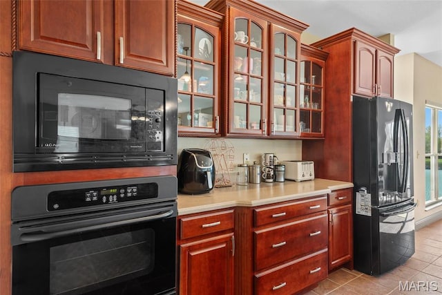 2017 Richview Dr, Saint Jacob, IL 62281 - kitchen with black appliances, light countertops, glass insert cabinets, and light tile patterned floors