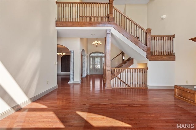 2017 Richview Dr, Saint Jacob, IL 62281 - unfurnished living room with a high ceiling, wood finished floors, arched walkways, a chandelier, and stairway