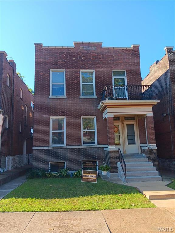 3464 Montana St, Saint Louis, MO 63118 - view of front facade featuring brick siding, a balcony, a front yard, and a porch