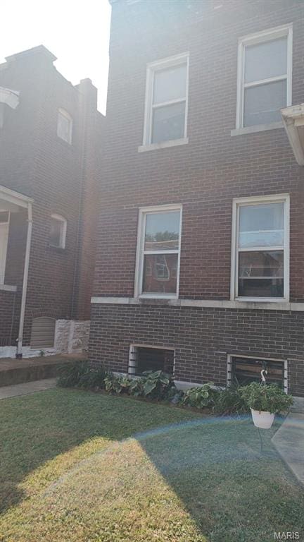 3464 Montana St, Saint Louis, MO 63118 - view of side of property featuring brick siding and a lawn