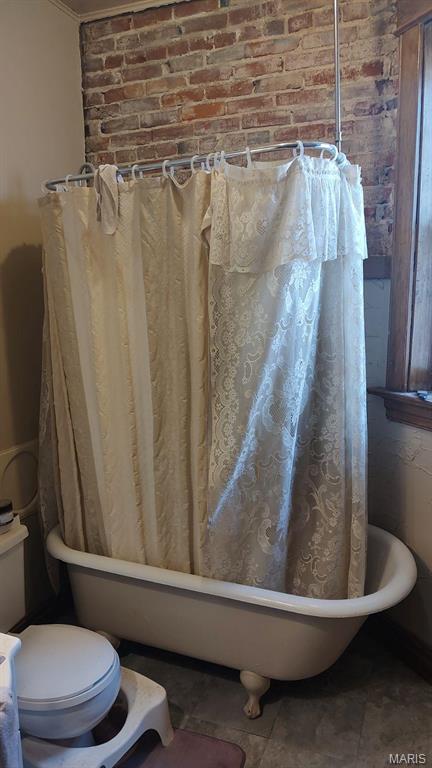 3464 Montana St, Saint Louis, MO 63118 - full bathroom featuring toilet, shower / bath combo, crown molding, and brick wall