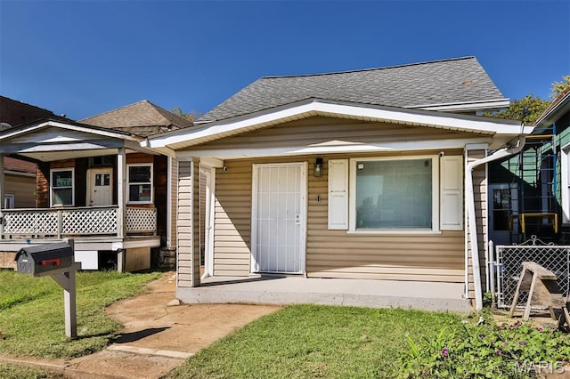 7613 Virginia Ave, Saint Louis, MO 63111 - view of front of property with roof with shingles, a porch, and fence