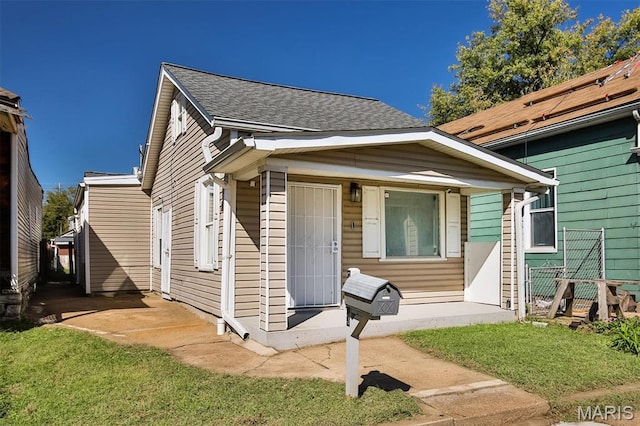 7613 Virginia Ave, Saint Louis, MO 63111 - view of front of property with a front lawn and a shingled roof