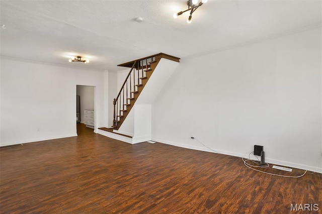 7613 Virginia Ave, Saint Louis, MO 63111 - unfurnished living room with stairs, wood finished floors, and baseboards