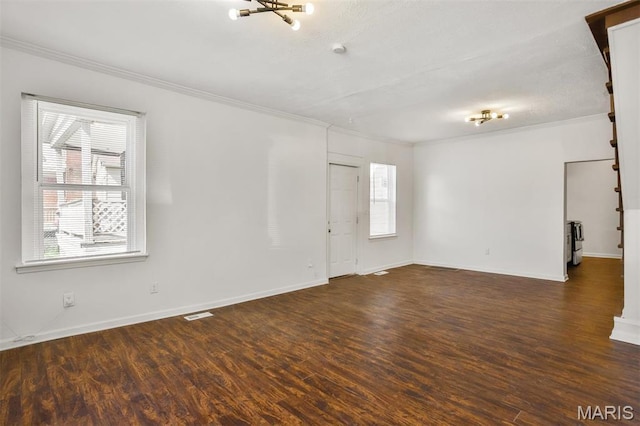 7613 Virginia Ave, Saint Louis, MO 63111 - spare room with ornamental molding, plenty of natural light, wood finished floors, baseboards, and a chandelier