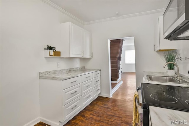 7613 Virginia Ave, Saint Louis, MO 63111 - kitchen featuring a sink, stainless steel microwave, dark wood-style flooring, crown molding, and white cabinetry