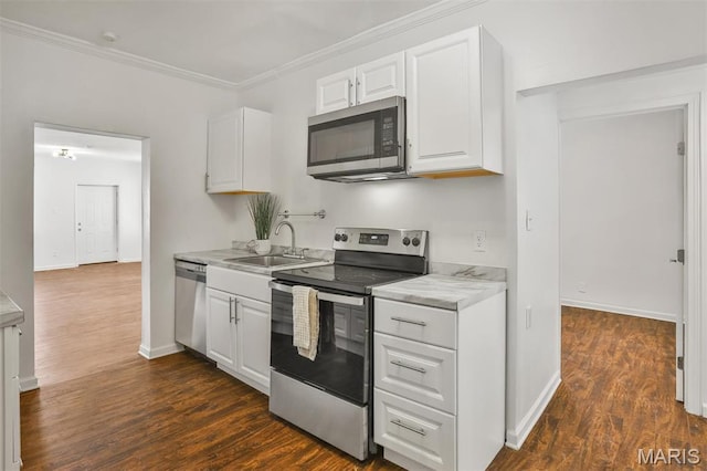7613 Virginia Ave, Saint Louis, MO 63111 - kitchen featuring appliances with stainless steel finishes, a sink, white cabinetry, light countertops, and dark wood finished floors