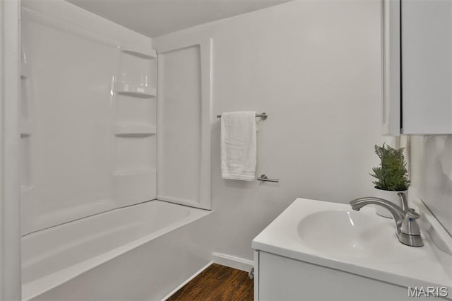 7613 Virginia Ave, Saint Louis, MO 63111 - bathroom with wood finished floors, baseboards, vanity, and shower / bathtub combination