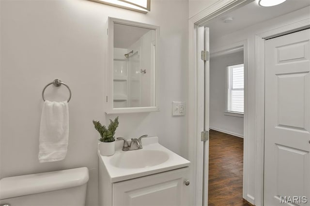 7613 Virginia Ave, Saint Louis, MO 63111 - full bathroom featuring toilet, vanity, wood finished floors, and a shower