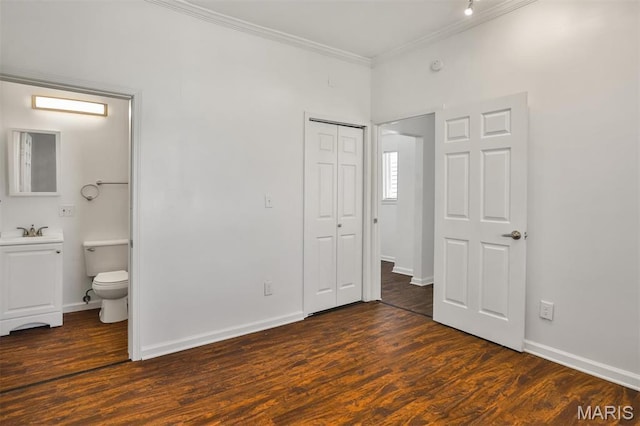 7613 Virginia Ave, Saint Louis, MO 63111 - unfurnished bedroom with crown molding, a sink, dark wood-style floors, a closet, and connected bathroom