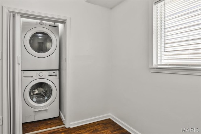 7613 Virginia Ave, Saint Louis, MO 63111 - washroom with estacked washer and dryer, dark wood-type flooring, and baseboards