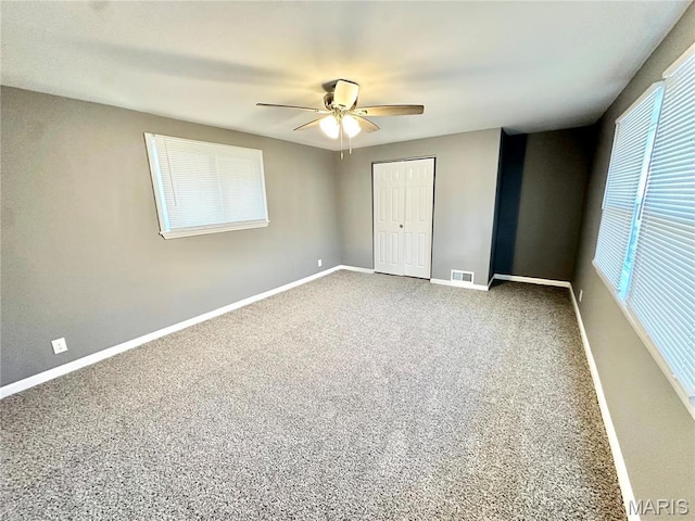 3345 Suncrest Ave, Saint Louis, MO 63114 - unfurnished bedroom featuring baseboards, carpet, a closet, and a ceiling fan