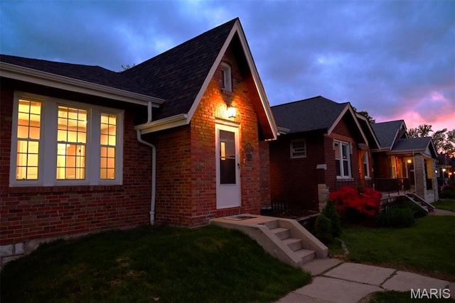5714 Rhodes Ave, Saint Louis, MO 63109 - view of front facade with brick siding and a yard