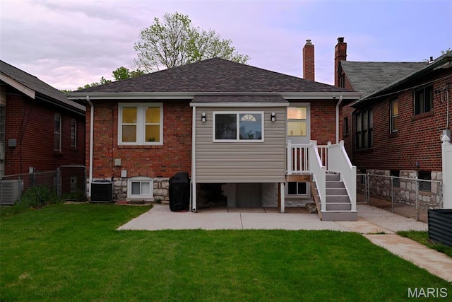 5714 Rhodes Ave, Saint Louis, MO 63109 - back of property with a chimney, central AC, brick siding, and a patio