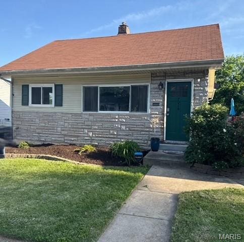7026 Winona Ave, Saint Louis, MO 63109 - view of front of home featuring stone siding, a front lawn, and a chimney