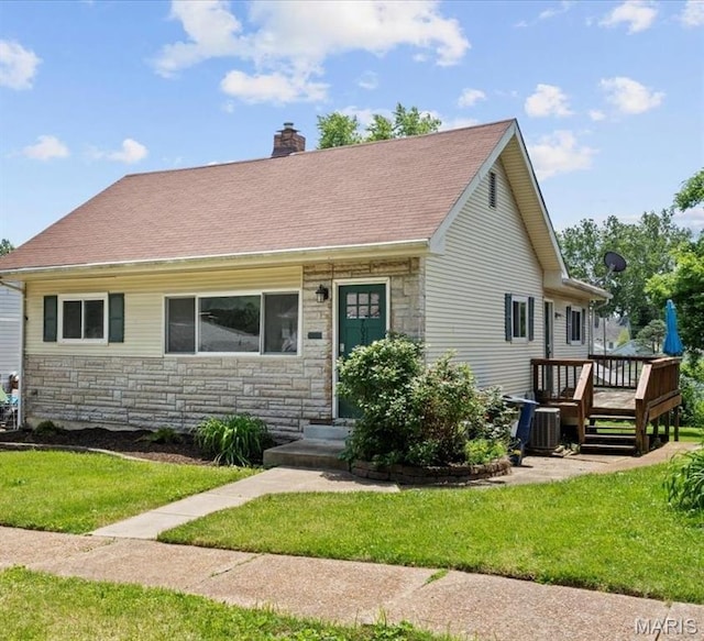 7026 Winona Ave, Saint Louis, MO 63109 - view of front of house featuring stone siding, a chimney, a front lawn, and a wooden deck