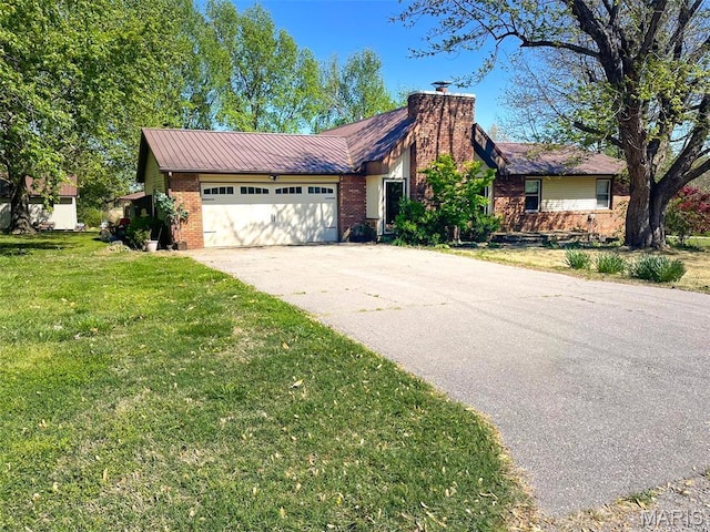 39988 Billy Blvd, Campbell, MO 63933 - view of front facade featuring brick siding, driveway, a chimney, a garage, and a front yard