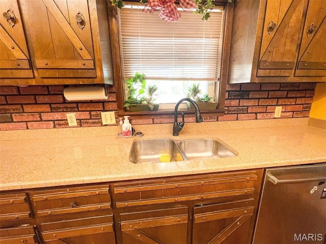 39988 Billy Blvd, Campbell, MO 63933 - kitchen with dishwasher, a sink, light stone countertops, and brown cabinetry