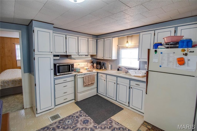 798 N Broadway, Kampsville, IL 62053 - kitchen featuring white appliances, a sink, under cabinet range hood, light flooring, and light countertops