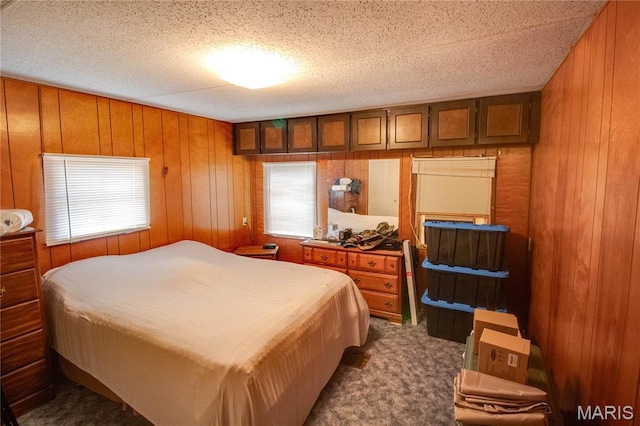 798 N Broadway, Kampsville, IL 62053 - bedroom featuring wood walls, dark colored carpet, and a textured ceiling