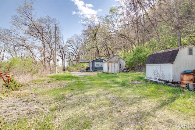 798 N Broadway, Kampsville, IL 62053 - view of green lawn with a storage shed and an outbuilding