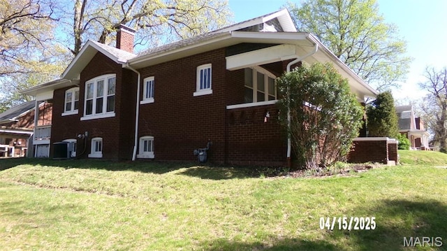 224 Voss Pl, Belleville, IL 62220 - view of property exterior featuring a chimney, a yard, brick siding, and cooling unit