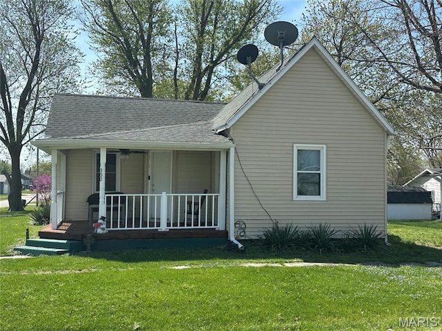 300 W 5th, New London, MO 63459 - rear view of house with covered porch, a yard, and roof with shingles