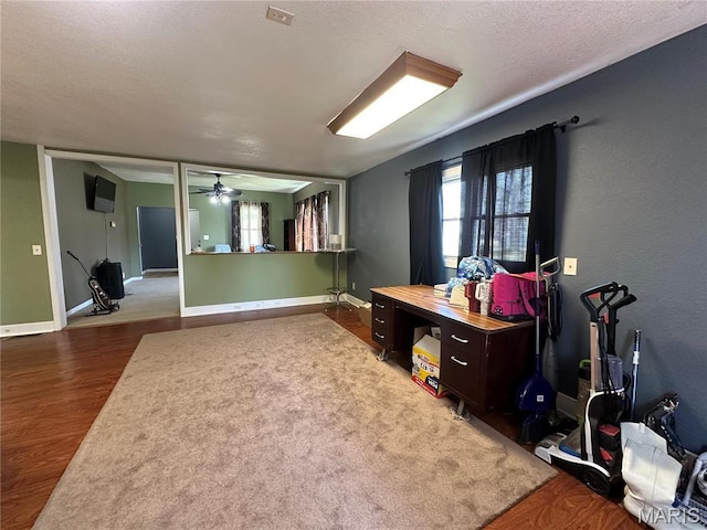 300 W 5th, New London, MO 63459 - interior space with wood finished floors, a ceiling fan, and baseboards