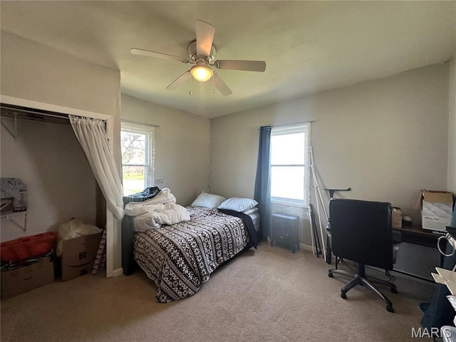 300 W 5th, New London, MO 63459 - bedroom featuring multiple windows, light carpet, a ceiling fan, and a desk