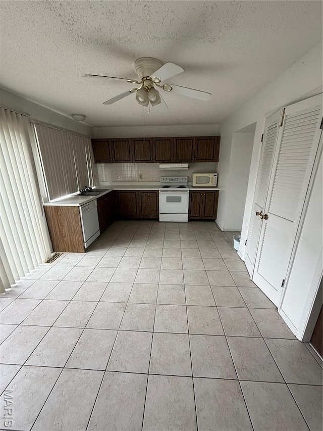 6919 Glenvale Ct, Florissant, MO 63033 - kitchen featuring white appliances, light countertops, a textured ceiling, light tile patterned floors, and ceiling fan