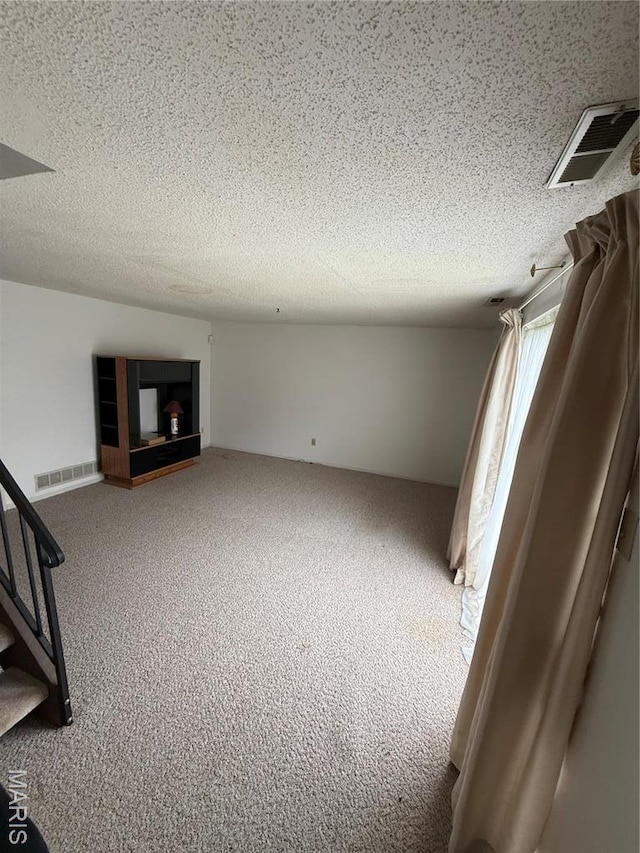 6919 Glenvale Ct, Florissant, MO 63033 - carpeted spare room with a textured ceiling and stairs