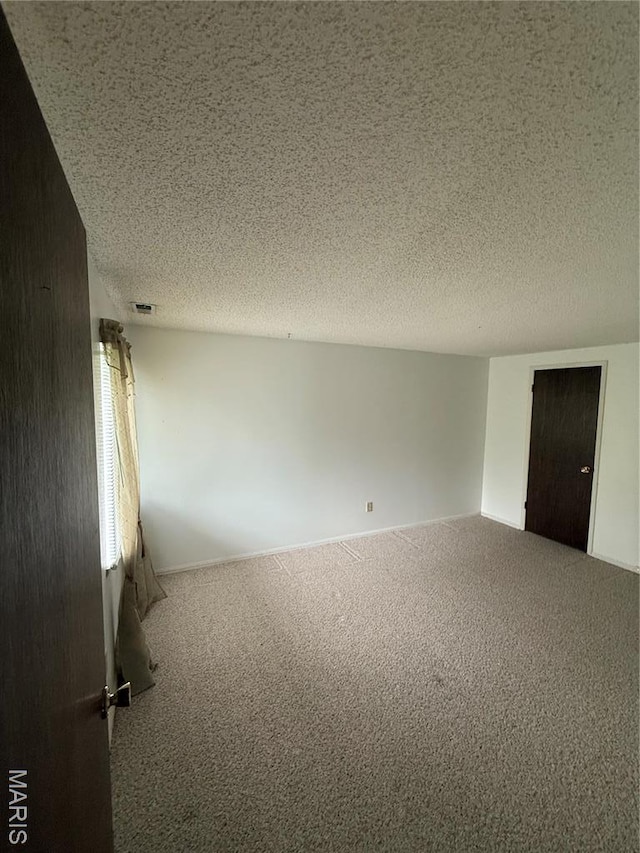6919 Glenvale Ct, Florissant, MO 63033 - carpeted empty room featuring a textured ceiling