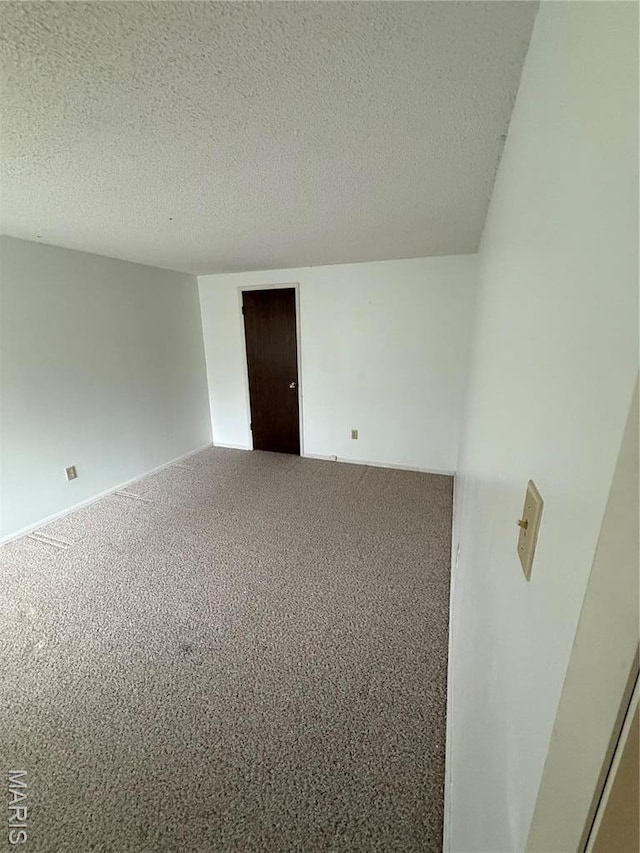 6919 Glenvale Ct, Florissant, MO 63033 - carpeted spare room featuring a textured ceiling