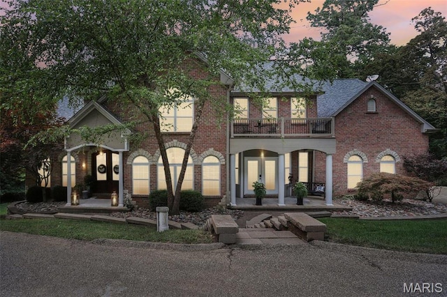 1002 Chesterfield Forest Dr, Wildwood, MO 63005 - view of front facade featuring a balcony, covered porch, brick siding, and french doors