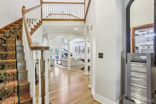 1002 Chesterfield Forest Dr, Wildwood, MO 63005 - foyer featuring stairs, ornate columns, wood finished floors, a towering ceiling, and baseboards