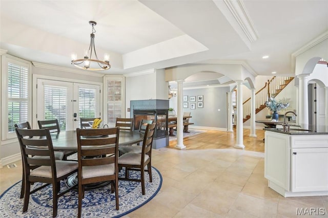 1002 Chesterfield Forest Dr, Wildwood, MO 63005 - dining space featuring decorative columns, arched walkways, ornamental molding, baseboards, and french doors