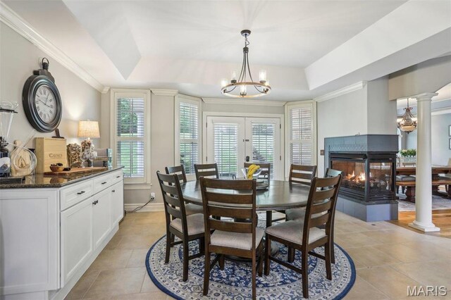 1002 Chesterfield Forest Dr, Wildwood, MO 63005 - dining room with a raised ceiling, a chandelier, plenty of natural light, a multi sided fireplace, and ornamental molding