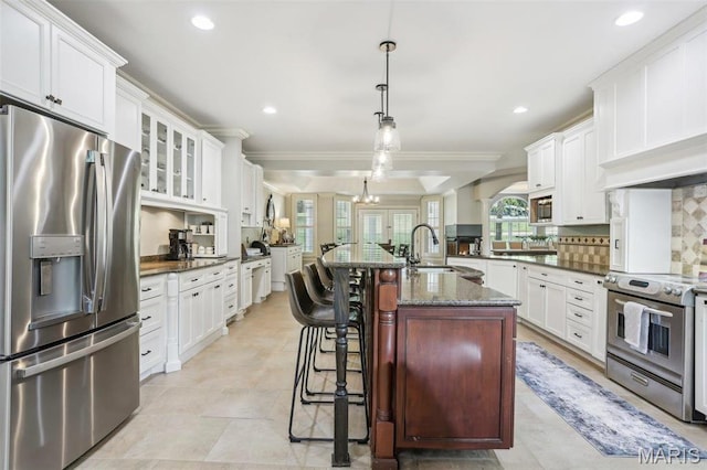1002 Chesterfield Forest Dr, Wildwood, MO 63005 - kitchen featuring stainless steel appliances, a sink, plenty of natural light, white cabinetry, and ornamental molding