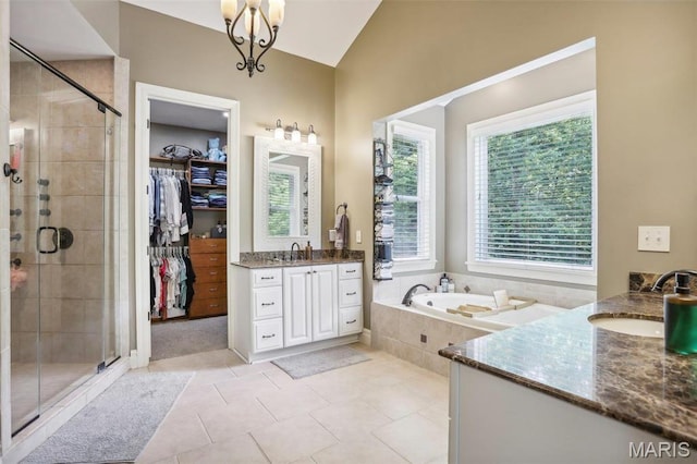 1002 Chesterfield Forest Dr, Wildwood, MO 63005 - bathroom with a shower stall, two vanities, lofted ceiling, a garden tub, and tile patterned flooring