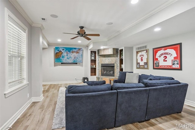 1002 Chesterfield Forest Dr, Wildwood, MO 63005 - living area with ceiling fan, light wood-type flooring, a tile fireplace, baseboards, and ornamental molding