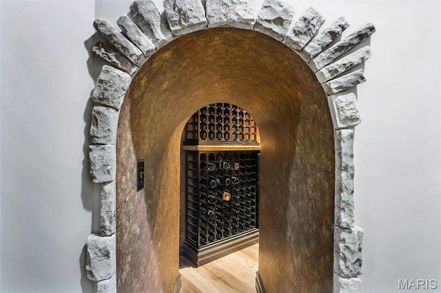 1002 Chesterfield Forest Dr, Wildwood, MO 63005 - wine room featuring wood finished floors and arched walkways