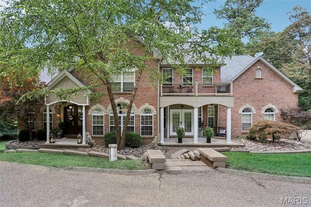 1002 Chesterfield Forest Dr, Wildwood, MO 63005 - view of front of home with french doors, a balcony, covered porch, and brick siding