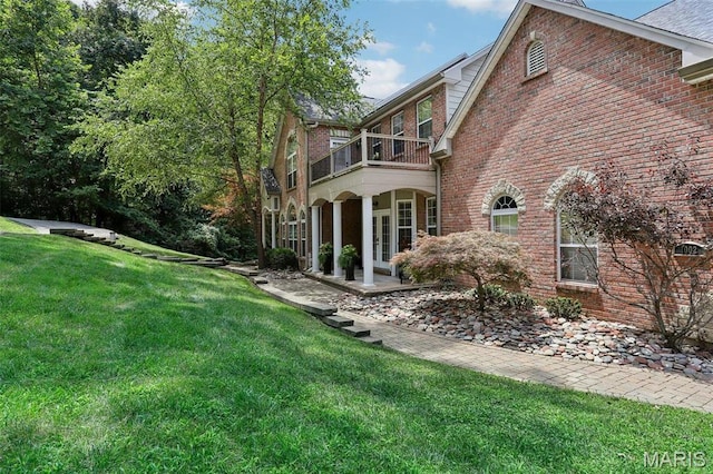1002 Chesterfield Forest Dr, Wildwood, MO 63005 - view of home's exterior featuring a balcony, a yard, brick siding, and french doors