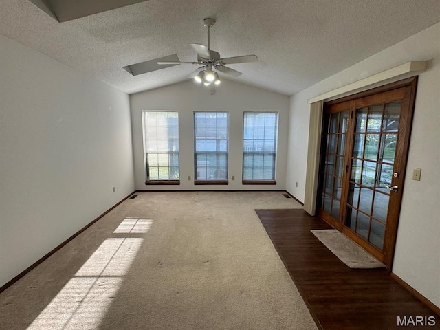 2925 Wayne Ave, Poplar Bluff, MO 63901 - carpeted spare room with vaulted ceiling, a ceiling fan, baseboards, and a textured ceiling