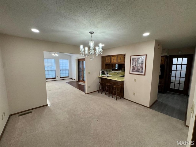 2925 Wayne Ave, Poplar Bluff, MO 63901 - carpeted dining room with a chandelier, baseboards, a textured ceiling, and recessed lighting