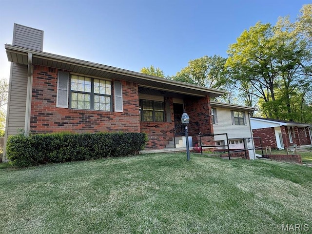 2925 Wayne Ave, Poplar Bluff, MO 63901 - view of front of property featuring brick siding, a front lawn, and a chimney