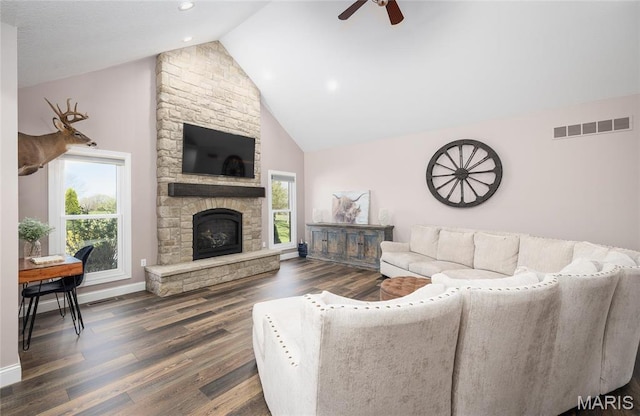 1100 Landon Rd, Bourbon, MO 65441 - living room with a ceiling fan, wood finished floors, baseboards, a stone fireplace, and high vaulted ceiling